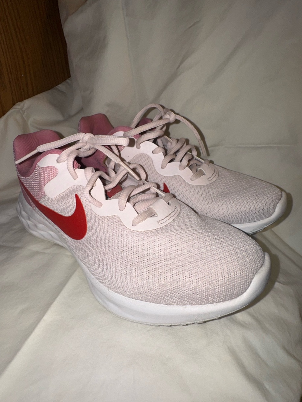 Nike Women's Pale Pink Running Sneakers with Red Swoosh
